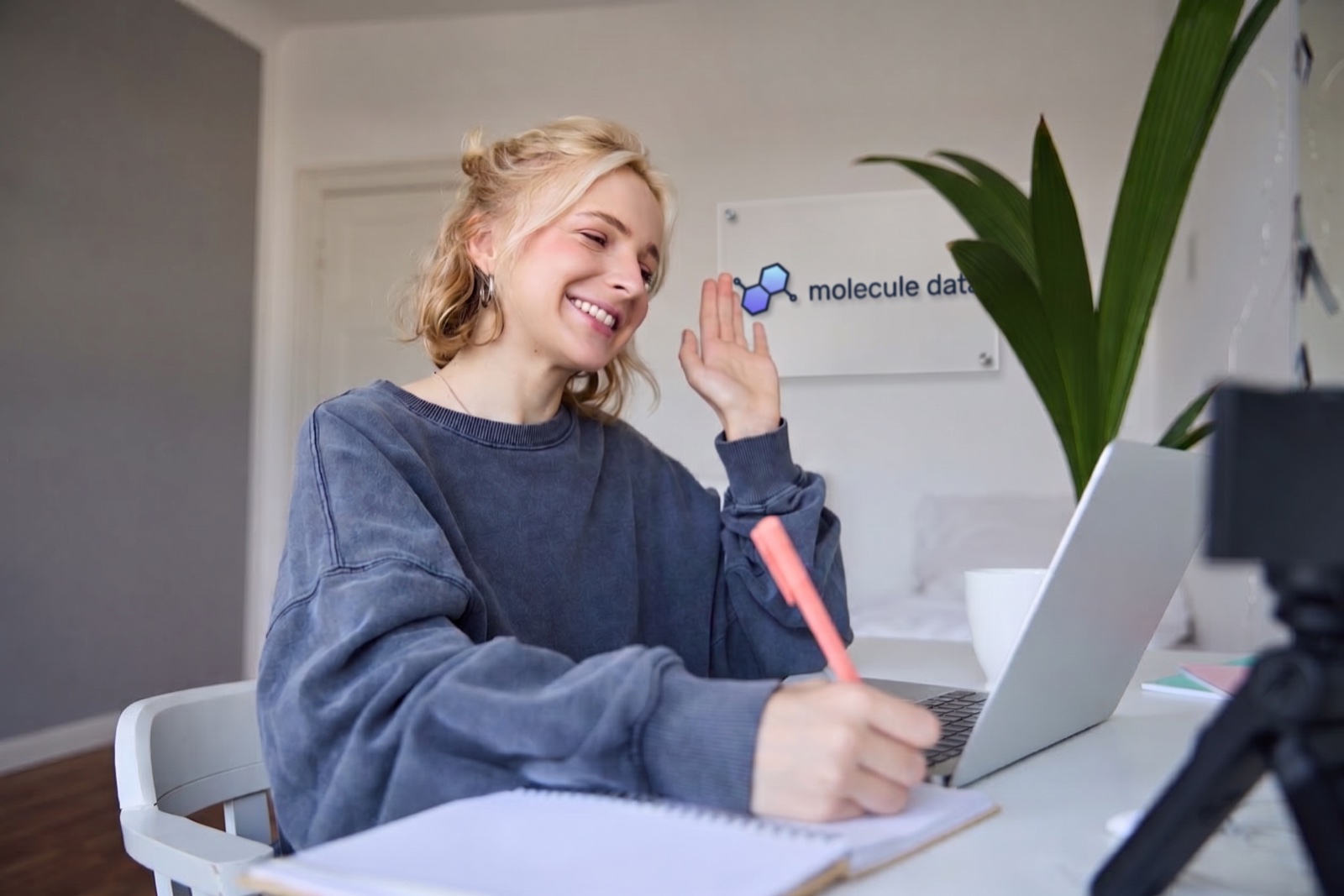 MoleculeData team member smiling at laptop